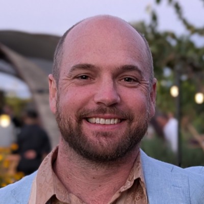 Headshot of white man with a short beard and not much hair.