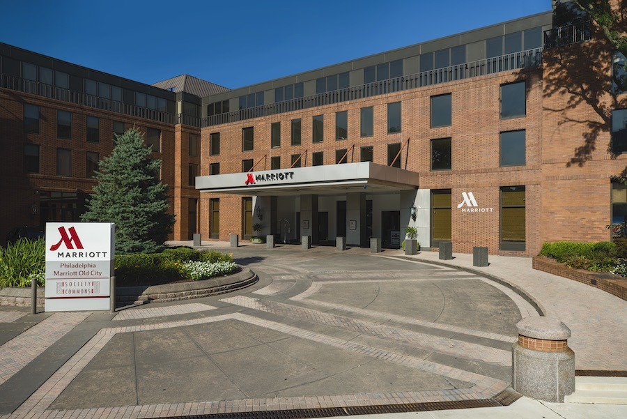 Photograph of the Marriott Old City hotel, with a circular driveway and sidewalk leading to a set of doors under an awning